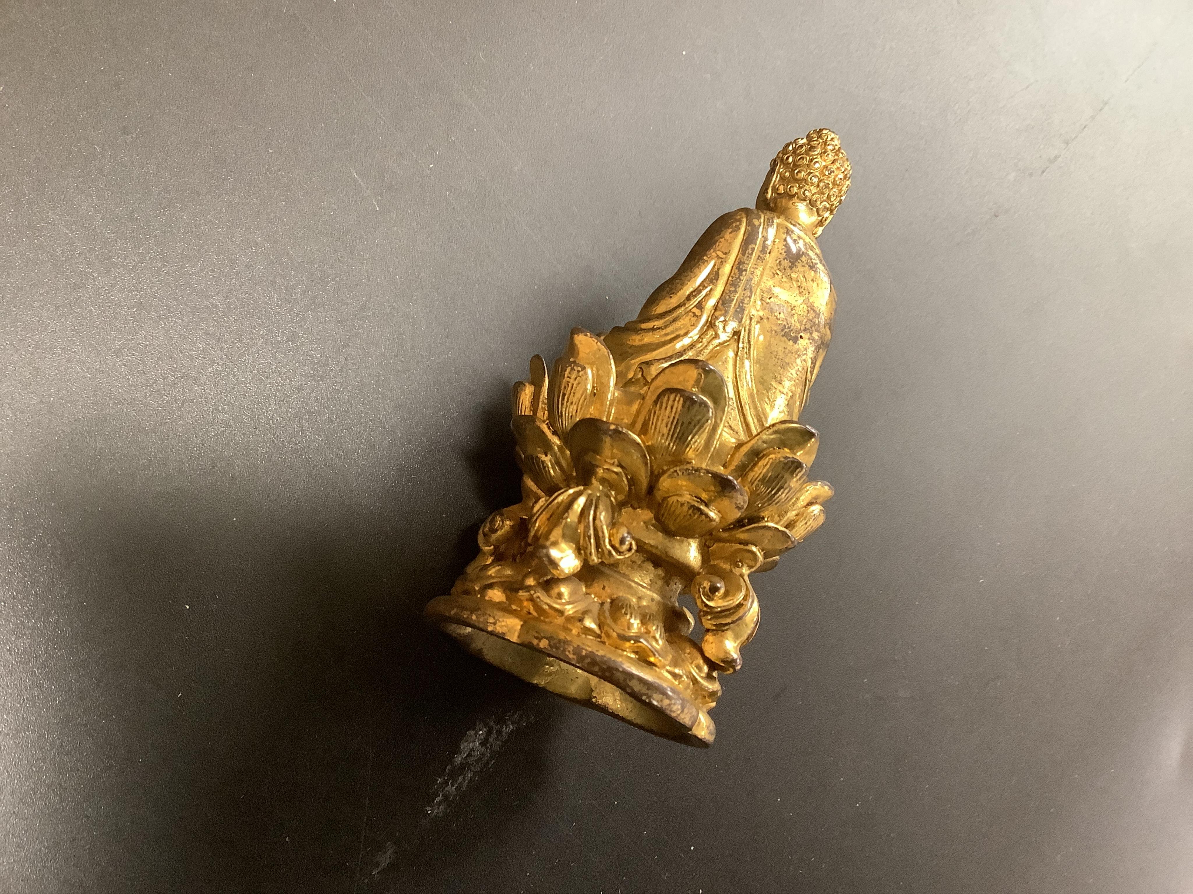 A Chinese miniature gilt metal figure of seated Buddha, 8cm high